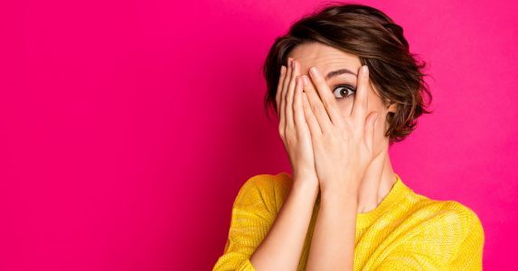 Close-up portrait of her she nice-looking attractive lovely pretty terrified, scared girl hiding face in palms hands feeling fear isolated bright vivid shine vibrant pink fuchsia color background